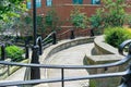 Inding roads and steps in Newcastle city centre with green trees and vibrant colourful flowers, stone and brick walls