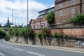 Inding roads and steps in Newcastle city centre with green trees and vibrant colourful flowers, stone and brick walls
