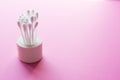 Individual ear sticks with plastic pick and cotton buds with selective focus on pink background. Clean ear swabs for personal ears Royalty Free Stock Photo