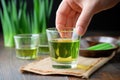 individual examining aloe vera juice in a clear glass Royalty Free Stock Photo