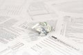 1040 Individual income tax return form and crumpled hundred dollar bill