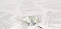 1040 Individual income tax return form and crumpled hundred dollar bill