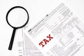 1040 Individual Income Tax Return Form with pen and magnifying glass up detailed close up. Concept for personal individual