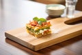 individual lasagna portion on a wooden board