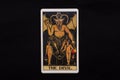 An individual major arcana tarot card isolated on black background. The Devil.