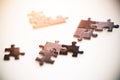 Individual parts of the black puzzle, illuminated by bright sunlight Royalty Free Stock Photo