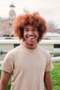 Individual portrait of one joyful african american guy with afro hair looking at camera with friendly expression. Young Royalty Free Stock Photo