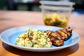 individual serving of potato salad with a side of grilled chicken