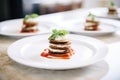 individual servings of eggplant parmesan on white plates