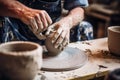 An individual skillfully shapes a vase by hand on a pottery wheel, showcasing the meticulous process of creating ceramics, potter