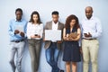 Individual skillsets make a team work. Studio shot of a group of businesspeople using their wireless devices while Royalty Free Stock Photo