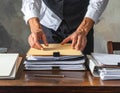 Person Organizing Documents and Files on Desk in Office Setting Royalty Free Stock Photo