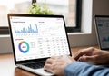 An individual types on a laptop displaying analytics dashboards Royalty Free Stock Photo