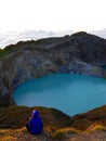 Individual watches awesome sunrise Kelimutu volcano, Flores, Indonesia