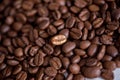 Individuality, standing out from a crowd concept, close up of a single bright, gold coffee bean over many dark ones with copy spac