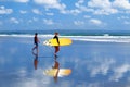 Indonesia, Bali Island, Kuta, beach - October 10, 2017: Surfers with a surfboard walking along the beach Royalty Free Stock Photo