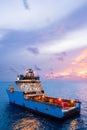 Newest Maersk Company Anchor Handling Offshore Supply Vessel maneuvering on the oil field at sunrise