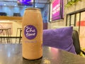 Indonesia, February 06, 2023: a bottle brown sugar coffee latte by Chatime Indonesia on a wooden table, defocused background Royalty Free Stock Photo