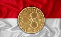 Indonesia flag, ripple gold coin on flag background. The concept of blockchain, bitcoin, currency decentralization in the country
