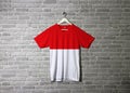Indonesia flag on shirt and hanging on the wall with brick pattern wallpaper Royalty Free Stock Photo