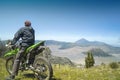 Indonesia June 23, 2020 : Man Traveller enjoying view Mount Bromo is an active volcano, Indonesia. Panorama Bromo with blue sky ba