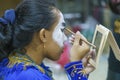 Indonesia, June 13 2022 - Men paint their faces in preparation for going on stage