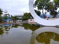 Indonesia, Palu City, 13 June 2023-The Palu City National Park Monument with the reflection of pond water