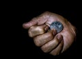 Indonesia rupiah coin in the hand of an asian person isolated