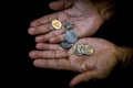 Indonesia rupiah coins in the hand of an asian person isolated
