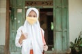 Indonesian asian primary student wearing a masks
