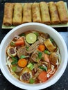 Soto mie aka beef noodle with spring rolls Royalty Free Stock Photo