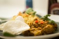 Beef Rendang with Yellow Rice and Shrimp Crackers, served on a banana leaf Royalty Free Stock Photo