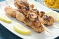 Indonesian chicken satay skewers with curry , peanut butter