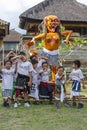 Indonesian children and Ogoh-ogoh statue built for the Ngrupuk parade, which takes place on the even of Nyepi day in Bali island,