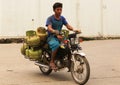 Indonesian delivery worker, motorcycle gas tanks, in Jakarta, Java, Indonesia