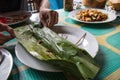 Indonesian dish PEPES IKAN from banana leaf on plate