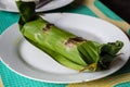 Indonesian dish PEPES IKAN closed in banana leaf