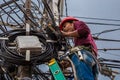 Indonesian electrician repair workers are to fix the line of network cable and wire on electric pole. Jakarta, Indonesia. Jule