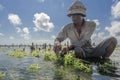 Indonesian farmer working in his sea farm for planting seaweed for cultivating more, Nusa Penida, Indonesia