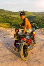 Indonesian father and daughter watching the sunset on the motorbike
