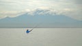 Indonesian fisherman catches a fish during. Royalty Free Stock Photo