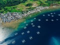 Indonesian fishing town and fishing boats in ocean on Sumbawa island. Scenic aerial view Royalty Free Stock Photo