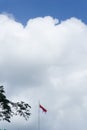 Indonesian flag isolated on blue sky with clipping path. close up of flying the red and white flag Royalty Free Stock Photo