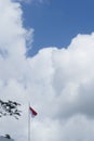 Indonesian flag isolated on blue sky with clipping path. close up of flying the red and white flag Royalty Free Stock Photo