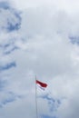 Indonesian flag isolated on blue sky with clipping path. close up of flying the red and white flag Royalty Free Stock Photo