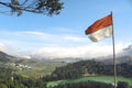 Indonesian Flag on Telaga Warna lake and mountain in Dieng Indonesia Royalty Free Stock Photo