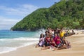 Indonesian funny children are photographed with a white lady on the Pantai Base beach in Sentani, Jayapura