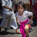 Indonesian girl lifting her skirt to walk stairs.