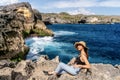 Indonesian girl take selfie by a smartphone at Broken Beach