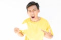 Indonesian guy pointing to a piece of paper and screaming on a white background Royalty Free Stock Photo